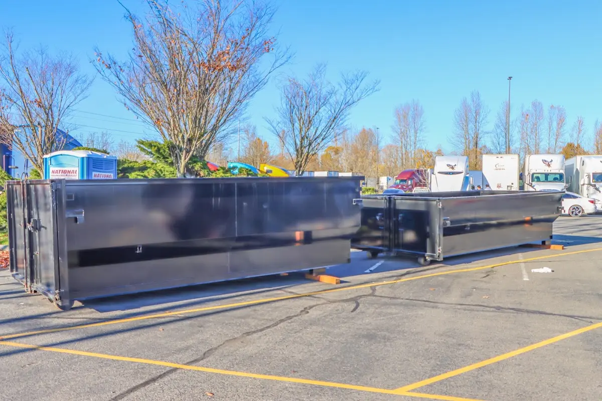 Professional dumpster rental service with roll-off container on residential driveway in Garfield